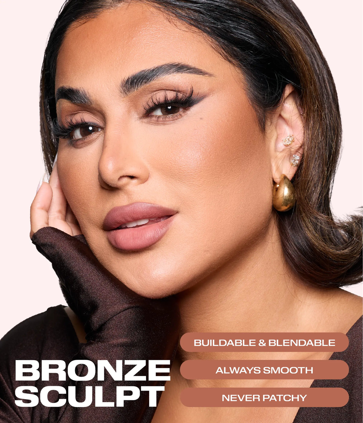 Huda Beauty founder Huda Kattan wearing Bronze Filter Palette bronzer, posing with a gloved hand on her cheek, text reading 'Bronze Sculpt', 'Buildable & blendable', 'Always smooth' and 'Never patchy'