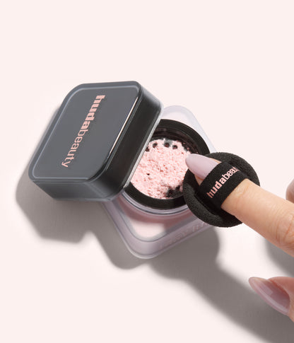 Mini Easy Bake Loose Baking & Setting Powder – Ube Birthday Cake loose powder shown in open jar with finger puff during application