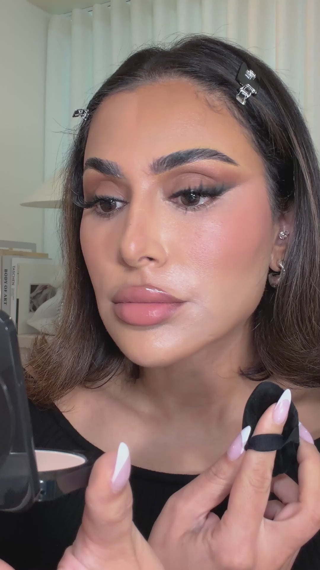 Huda applying Easy Bake Pressed Powder for an airbrush finish