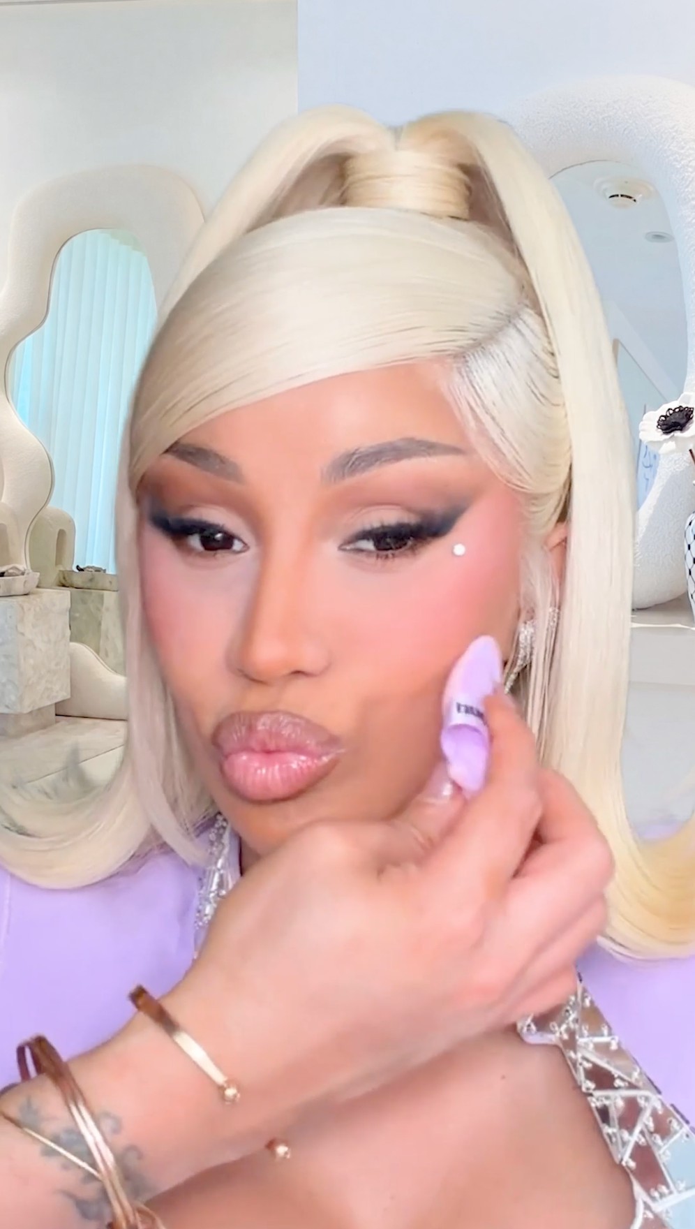 CardiB is trying the ultra snatched collection on herself 