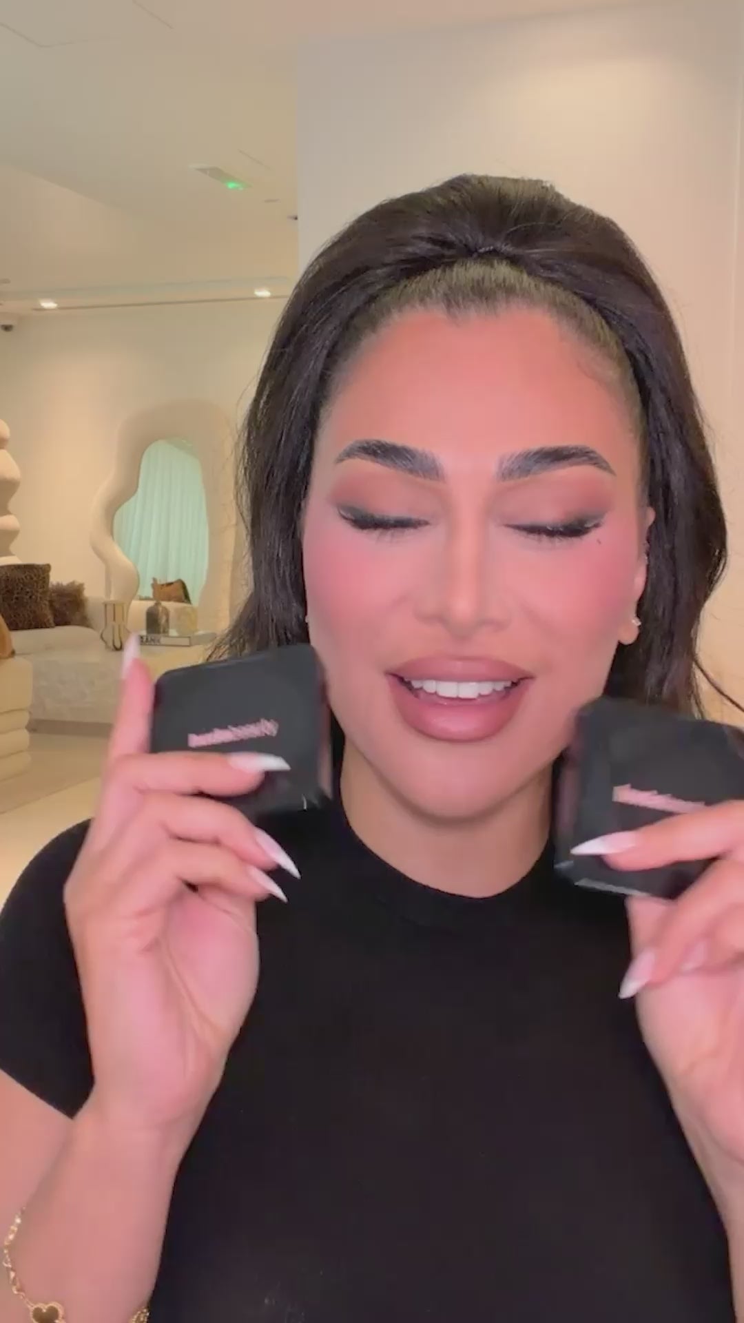 Huda is trying the ultra snatched pressed powder, Ube Birthday Cake and Pink Velvet Cookie shades